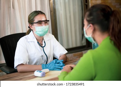 Happy Doctor Female Wearing Face Mask. Attending To Her Patient In A Consultation While Prepair Digital Fever Meter. Thermometers. 
Concept Virus Protection