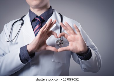 Happy doctor man showing heart shape