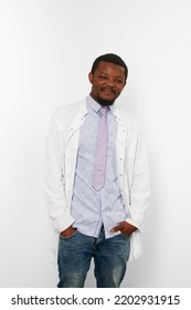 Happy Doctor Man With Small Beard In White Coat, Bright Shirt And Jeans, Isolated On White Background. Smiling Adult Black African American Physician Therapist Half Size Portrait, Candid Emotion