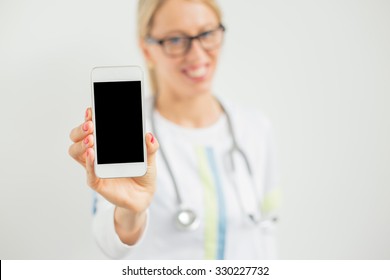 Happy doctor showing her phone  - Powered by Shutterstock