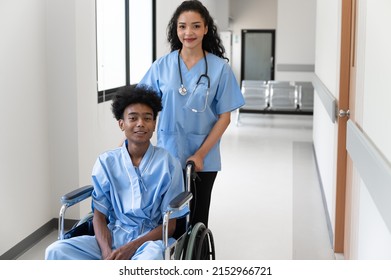 Happy Doctor Woman With Teen Patient In Wheelchair At Hospital 