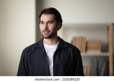 Happy Dreamy Handsome Young 30s Man In Casual Clothes Looking In Distance, Visualizing Future, Imagining Career Opportunities, Posing At Home, Property Ownership, Real Estate Services Concept.