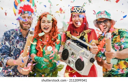 Happy Dressed People Celebrating At Carnival Party Throwing Confetti - Focus On Left Girl Hands