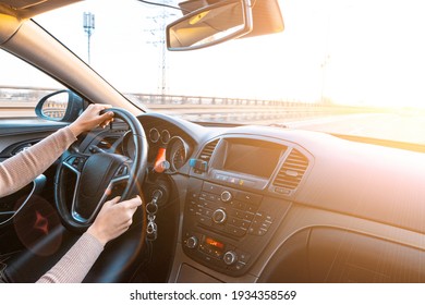 Happy Driver Inside Car At Sunset. Young Woman Have Fun Ride Trip Travel On Road In Winter Sunny Day. Drive Vacation Concept