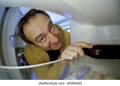 Happy Drunken Man Getting The Last Beer From The Fridge.