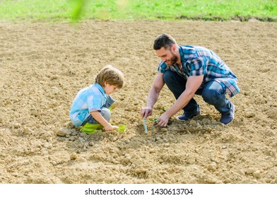 happy earth day. Family tree. father and son planting flowers in ground. small boy child help father in farming. earth day. new life. soils fertilizers. rich natural soil. Eco farm. Caring gardener. - Powered by Shutterstock