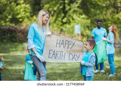 Happy Earth Day! People Cleaning Up Litter On Grass. Group Of International Young People Building Team Outdoor In Park. Volunteer Together Pick Up Trash In The Park