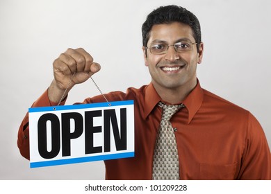 Happy East Indian Business Owner Holding An Open Sign