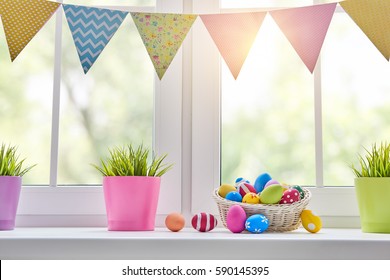 Happy Easter! Background With Colorful Eggs In Basket. Window Decorating For Holiday.