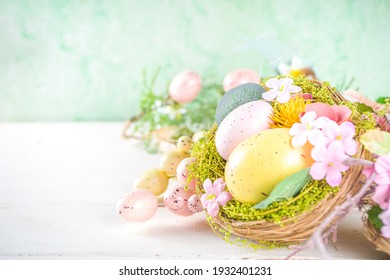 Happy easter background with Nests decoration, colorful eggs and Spring Flowers. Greeting card on sunny spring background