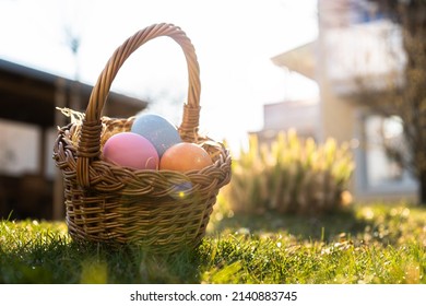 Happy Easter. Basket with Easter eggs in grass on a sunny spring day - Easter decoration, banner, panorama, background with copy space for text. - Shutterstock ID 2140883745