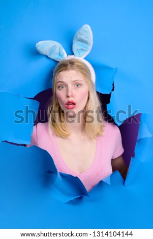 Happy easter! Bunny ears. Woman through paper. Surprised woman looking through paper. Egg hunt. Easter. Bunny. Easter hunt. Bunny ears. Breaking paper. Easter Sale. Discount. Sales.