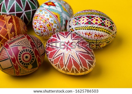 happy easter card. beautiful Easter egg Pysanka handmade - ukrainian traditional on a yellow background