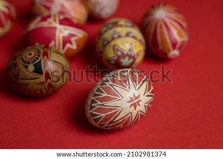 happy easter card. beautiful Easter egg Pysanka handmade on a red background