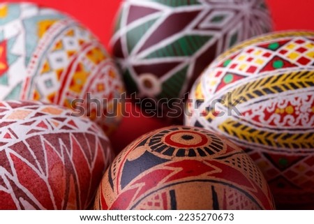 happy easter card. beautiful Easter egg Pysanka handmade on a red background