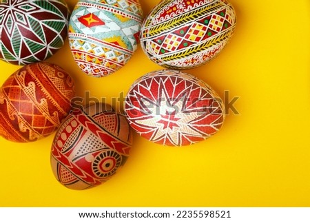 happy easter card. beautiful Easter egg Pysanka handmade on a yellow background