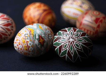 happy easter card. beautiful Easter egg Pysanka handmade on a black background