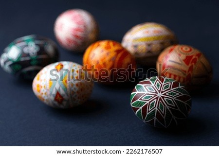 happy easter card. beautiful Easter egg Pysanka handmade on a black background