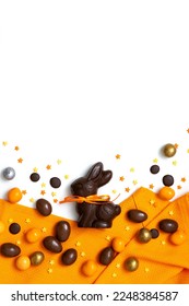 Happy Easter concept. Delicious chocolate Easter bunny, eggs, sweets, almonds on white table background with orange towel. Preparation for holiday. Simple minimalism flat lay, copy space on top - Shutterstock ID 2248384587