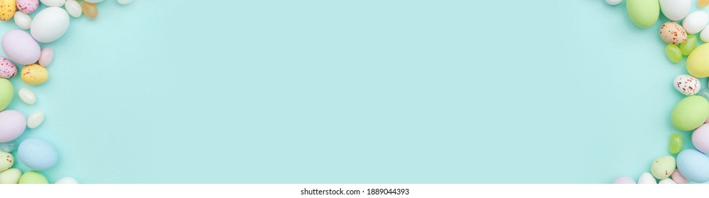 Happy Easter concept. Preparation for holiday. Easter candy chocolate eggs and jellybean sweets isolated on trendy pastel blue background. Simple minimalism flat lay top view copy space banner - Powered by Shutterstock