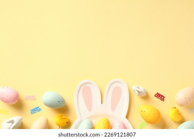 Happy Easter concept. Table serving cutlery and colorful eggs on yellow background
