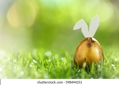 Happy easter day on april, Easter gold eggs and cute bunny in green grass. Selective focus and toned image. - Powered by Shutterstock