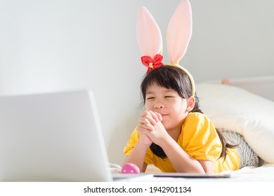 Happy Easter Day.Asian Child Girl In Rabbit Ears Pray.Faith Prayer Online Worship In Easter Day Home.Kid With Faith Trust.Healthcare, Easter Worship Home Church.Lockdown, Covid19 Coronavirus.online.