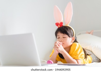 Happy Easter Day.Asian Child Girl In Rabbit Ears Pray.Faith Prayer Online Worship In Easter Day Home.Kid With Faith Trust.Healthcare, Easter Worship Home Church.Lockdown, Covid19 Coronavirus.online.