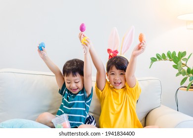 Happy easter day.asian sibling boy girl hunt eggs at home.Online easter holidays.Kids child with colorful eggs.sister brother playing easter egg hunt.Lockdown, covid19, spring.Stay home.Medical health