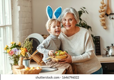 Happy Easter! Family Grandmother And Child Grandson With Ears Hare Getting Ready For Holiday
