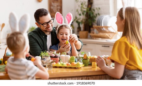 Happy Easter! Family Mother, Father And Children Paint Eggs For The Holiday