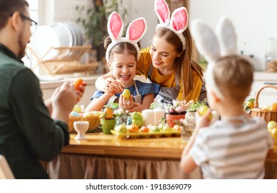 Happy Easter! Family Mother, Father And Children Paint Eggs For The Holiday