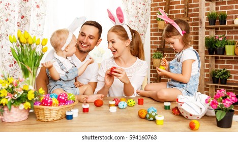 Happy Easter! Family Mother, Father And Children Having Fun Paint And Decorate Eggs For Holiday
