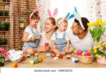 Happy Easter! Family Mother, Father And Children Having Fun Paint And Decorate Eggs For Holiday
