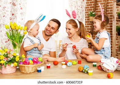 Happy Easter! Family Mother, Father And Children Having Fun Paint And Decorate Eggs For Holiday
