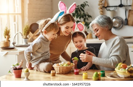 Happy Easter! Family Mother, Grandmother And Children Paint Eggs For The Holiday