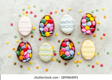 Happy Easter flat lay of chocolate eggs and sweets, top view