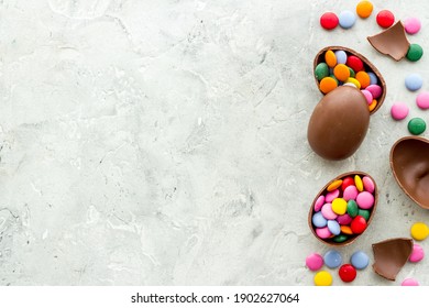 Happy Easter flat lay of chocolate eggs and sweets, top view