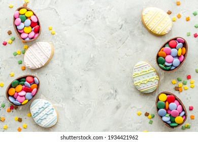 Happy Easter flat lay of chocolate eggs and sweets, top view