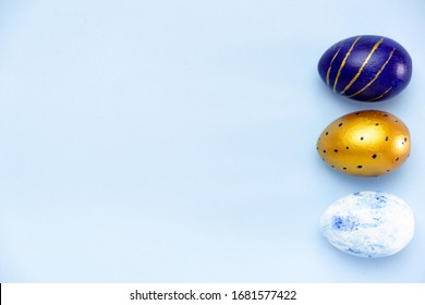 Happy Easter. Frame for text made of easter eggs trendy colored classic blue, white and golden on blue. Minimal style, top view, flatlay, copy space