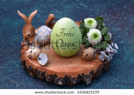 Happy Easter greeting card: Harmonious Easter decoration with Easter eggs in a nest, one of which is inscribed with the text Happy Easter.	The German inscription translates as Frohe Ostern.