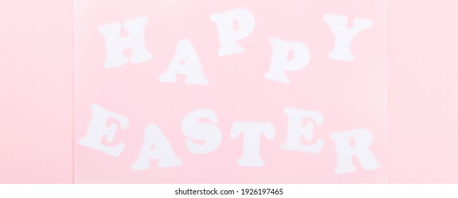 Happy Easter Greeting Card with the inscription on a pink paper background.Concept of festive greetings.