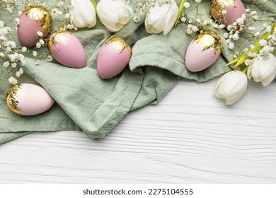 Happy Easter holiday greeting card. Bouquet of white tulips and Easter egg on white wooden background. Space for text