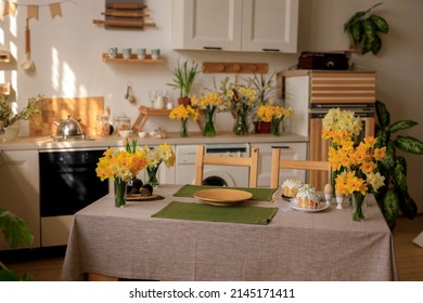 Happy Easter! Home Interior Kitchen With Fresh Flowers Daffodils And Easter Cakes