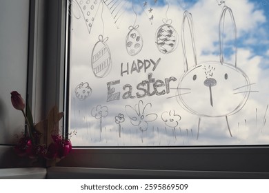 HAPPY EASTER message Zero cost responsible holiday decor economically driven. Painted Easter bunny rabbit on window glass indoor at home. Affordable alternative Easter springtime seasonal tradition