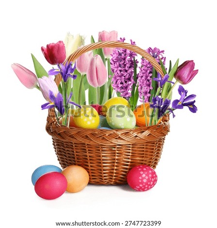 Happy Easter. Painted eggs and beautiful flowers in wicker basket on white background