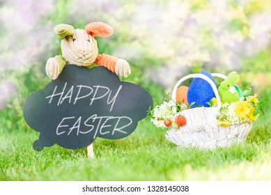 Happy Easter Text On Blackboard And Basket With Eastertide Symbols