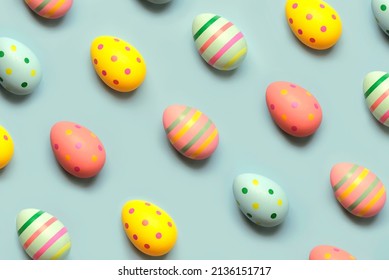 Happy Easter. Top view of creative pattern made of colored easter painted eggs over blue background