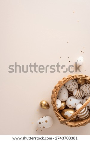 Happy Easter vertical greeting concept with gold and white painted eggs arranged in a wicker basket beside pussywillow branches for elegant spring celebration