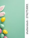 Happy Easter vertical greeting featuring pastel painted eggs, decorative bunny ears and space for a message on a mint background